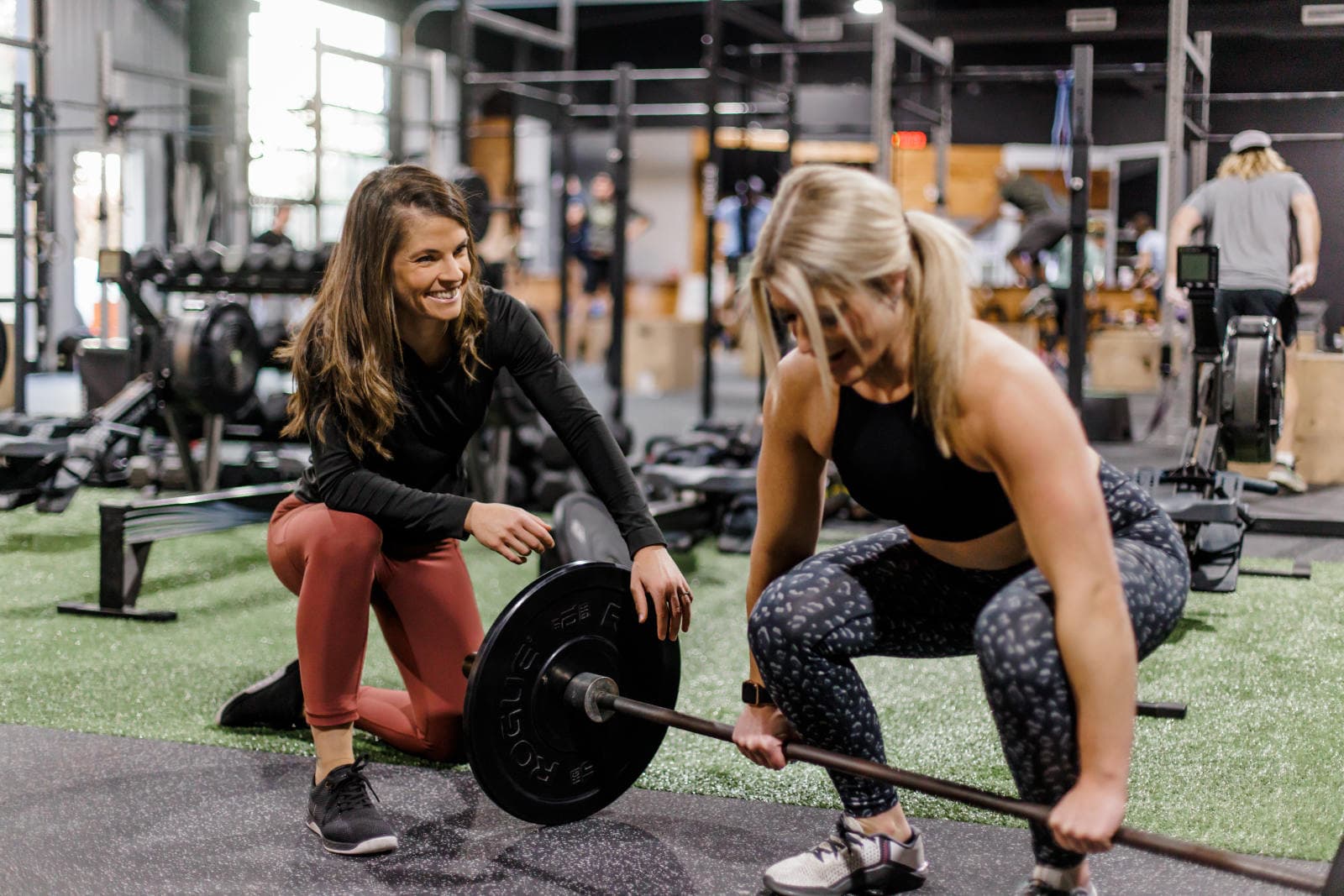 A coach spotting a member during a lift